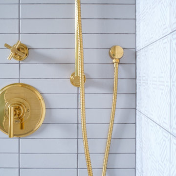 White and Hand Painted Tiles Shower with Gold Hardware