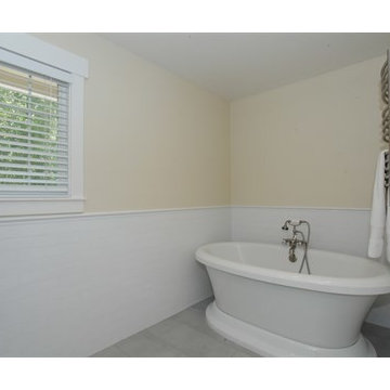 white bathroom, marble counters, subway tile, free standing tub