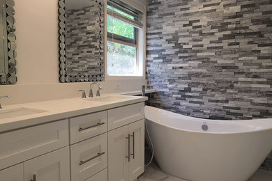 Inspiration for a mid-sized transitional master white tile and porcelain tile porcelain tile and gray floor bathroom remodel in Los Angeles with recessed-panel cabinets, white cabinets, a bidet, white walls, an undermount sink, quartz countertops, a hinged shower door and white countertops