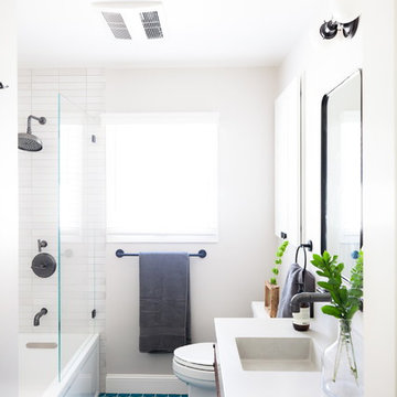 White Bathroom with Bright Blue Hexagon Floor Tiles