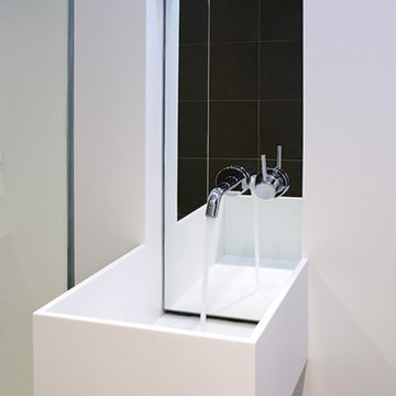 white corian and concrete bathroom