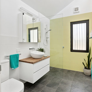 Inspiration for a contemporary 3/4 bathroom in Perth with flat-panel cabinets, white cabinets, a curbless shower, a two-piece toilet, yellow tile, white walls, a vessel sink, wood benchtops, grey floor, an open shower and brown benchtops.