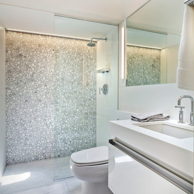 Inspiration for a small contemporary 3/4 white tile porcelain tile alcove shower remodel in Minneapolis with an undermount sink, white cabinets, solid surface countertops, a one-piece toilet and flat-panel cabinets