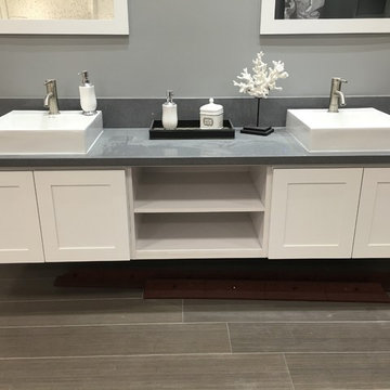 White shaker cabinetry with quartz counter top, concrete color and white porcela