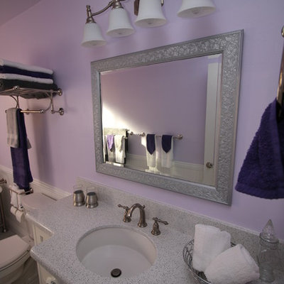 Claw-foot bathtub - mid-sized traditional 3/4 gray tile and stone tile marble floor claw-foot bathtub idea in Other with an undermount sink, beaded inset cabinets, white cabinets, quartz countertops, a two-piece toilet and purple walls