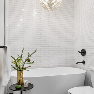 Transitional black floor freestanding bathtub photo in Chicago