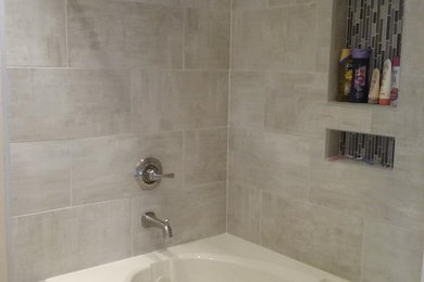 Example of a mid-sized trendy master beige tile and porcelain tile porcelain tile and beige floor bathroom design in Indianapolis with shaker cabinets, brown cabinets, a hot tub, a two-piece toilet, a vessel sink and tile countertops