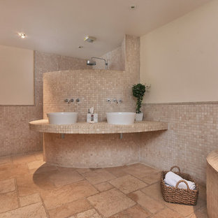 Medium sized mediterranean wet room bathroom in Other with a corner bath, beige tiles, mosaic tiles, beige walls, a vessel sink, beige floors, an open shower and beige worktops.