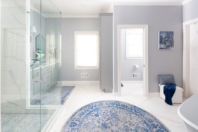 Inspiration for a large coastal master white tile and porcelain tile porcelain tile and white floor bathroom remodel in Atlanta with shaker cabinets, gray cabinets, a two-piece toilet, blue walls, quartzite countertops, a hinged shower door, white countertops and an undermount sink