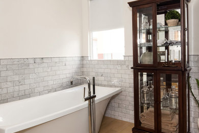 Inspiration for a mid-sized country master yellow tile and subway tile light wood floor bathroom remodel in Los Angeles with shaker cabinets, dark wood cabinets, a one-piece toilet, white walls, an undermount sink and quartz countertops