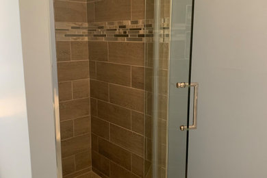 Example of a small trendy master marble floor alcove shower design in Bridgeport with shaker cabinets, a hinged shower door, a niche and a freestanding vanity