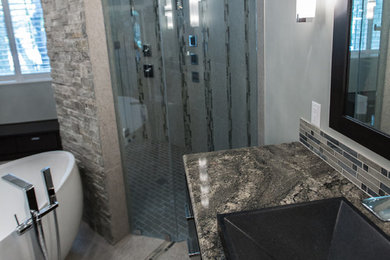 Bathroom - large contemporary master gray tile and porcelain tile porcelain tile bathroom idea in Austin with a drop-in sink, flat-panel cabinets, dark wood cabinets, granite countertops and gray walls