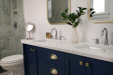 Inspiration for a mid-sized mid-century modern kids' white tile and marble tile marble floor, white floor and double-sink bathroom remodel with shaker cabinets, blue cabinets, a two-piece toilet, white walls, an undermount sink, quartz countertops, white countertops, a niche and a freestanding vanity