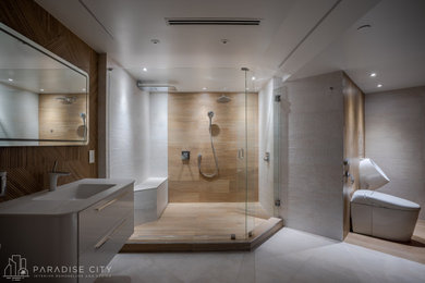 Double shower - large contemporary master gray tile and ceramic tile porcelain tile and white floor double shower idea in Miami with glass-front cabinets, white cabinets, an urinal, beige walls, an integrated sink, solid surface countertops and a hinged shower door