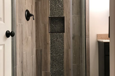Inspiration for a transitional beige tile and porcelain tile light wood floor corner shower remodel in DC Metro with white walls