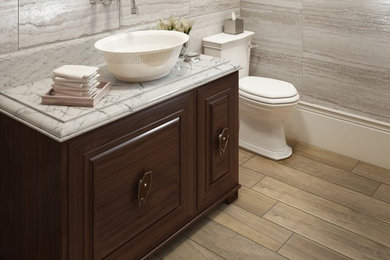 Inspiration for a mid-sized contemporary 3/4 medium tone wood floor bathroom remodel in Dallas with raised-panel cabinets, dark wood cabinets, a two-piece toilet, gray walls and a vessel sink