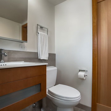 Wood Grain Sliding Door and Floating Vanity in Small Bathroom