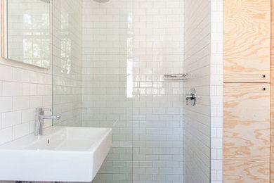 Trendy white tile and subway tile bathroom photo in New York with a wall-mount sink