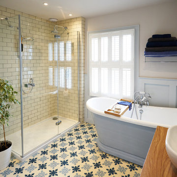 Wood panelled main bathroom with encaustic flooring and large shower