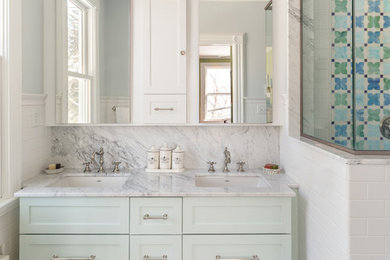 Alcove shower - mid-sized transitional 3/4 white tile and subway tile marble floor and multicolored floor alcove shower idea in New York with shaker cabinets, blue cabinets, white walls, an undermount sink, marble countertops, a hinged shower door and multicolored countertops