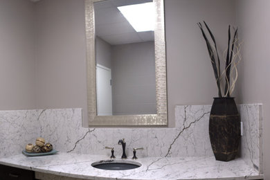 Mid-sized elegant bathroom photo in Toronto with raised-panel cabinets, dark wood cabinets, an undermount sink, quartz countertops and white countertops
