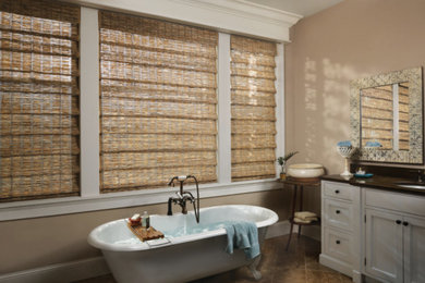 This is an example of a classic sauna bathroom in Other with shaker cabinets, white cabinets, a claw-foot bath, beige walls and a submerged sink.