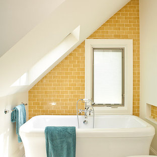 Photo of a beach style bathroom in Atlanta with a freestanding tub, subway tile, yellow tile, yellow walls, mosaic tile floors and white floor.