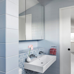 Design ideas for a large contemporary bathroom in Brisbane with white cabinets, an alcove tub, a one-piece toilet, blue tile, ceramic tile, white walls, a wall-mount sink and a hinged shower door.