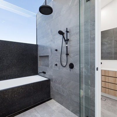 Mid-sized trendy master gray tile, black tile and porcelain tile porcelain tile and gray floor bathroom photo in Sydney with medium tone wood cabinets, white walls, laminate countertops, flat-panel cabinets, an undermount sink and white countertops