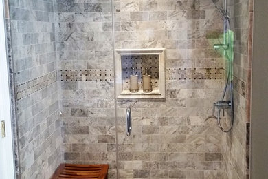 Alcove shower - mid-sized 3/4 beige tile and porcelain tile porcelain tile and beige floor alcove shower idea in Nashville with gray walls and a hinged shower door