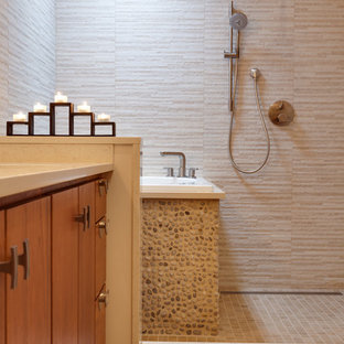 Foto de cuarto de baño principal, de estilo zen, grande, con lavabo bajoencimera, armarios con paneles lisos, puertas de armario de madera oscura, encimera de mármol, bañera japonesa, ducha abierta, sanitario de pared, baldosas y/o azulejos beige, baldosas y/o azulejos de cerámica, paredes beige y suelo de baldosas de cerámica