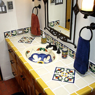 Mid-sized elegant 3/4 blue tile, white tile, yellow tile and ceramic tile brick floor and red floor bathroom photo in Portland with raised-panel cabinets, light wood cabinets, a one-piece toilet, white walls, an integrated sink and tile countertops