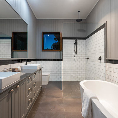 Inspiration for a mid-sized contemporary master black tile, white tile and subway tile ceramic tile and gray floor bathroom remodel in Brisbane with beaded inset cabinets, gray cabinets, a one-piece toilet, gray walls, an integrated sink and granite countertops