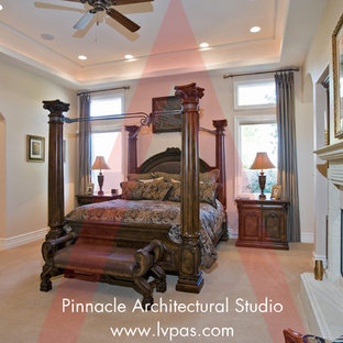 Imagen de dormitorio principal y abovedado, mediterráneo, extra grande, con paredes beige, suelo de madera en tonos medios, chimenea tradicional, marco de chimenea de hormigón y suelo marrón