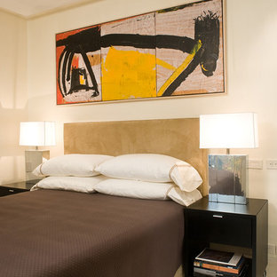 Modelo de habitación de invitados actual, pequeña, con paredes beige y suelo de piedra caliza