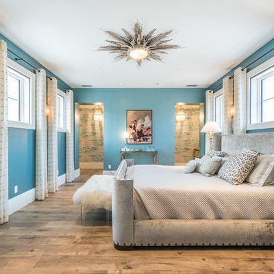 Inspiration for a tropical light wood floor bedroom remodel in Miami with blue walls