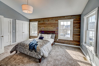 Mountain style master carpeted bedroom photo in New York with blue walls and no fireplace
