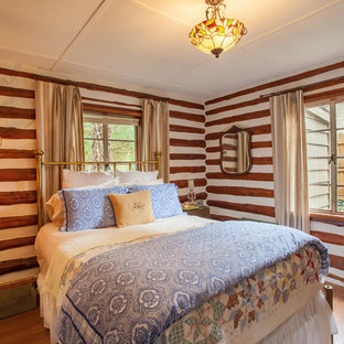 Ejemplo de habitación de invitados rural, pequeña, con suelo laminado