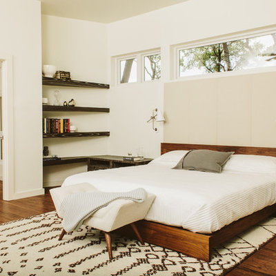 Inspiration for a modern dark wood floor bedroom remodel in Austin with white walls