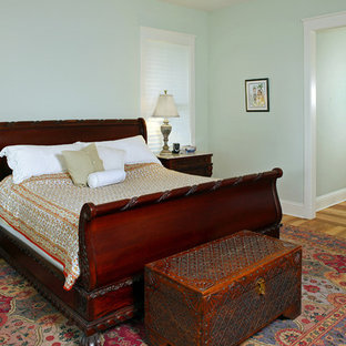 Example of a classic medium tone wood floor bedroom design in Jacksonville with green walls