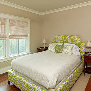Elegant guest medium tone wood floor bedroom photo in Charleston with beige walls