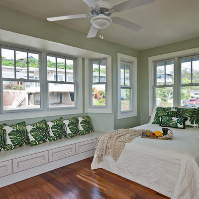 Inspiration for a tropical medium tone wood floor bedroom remodel in Hawaii with green walls