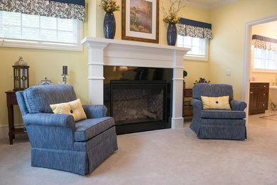 Example of a classic master carpeted and white floor bedroom design in Other with yellow walls, a standard fireplace and a stone fireplace
