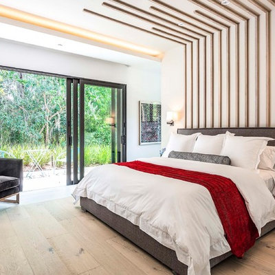 Bedroom - contemporary master light wood floor and beige floor bedroom idea in Orlando with white walls