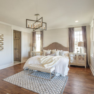 Inspiration for a transitional medium tone wood floor and brown floor bedroom remodel in Nashville with beige walls