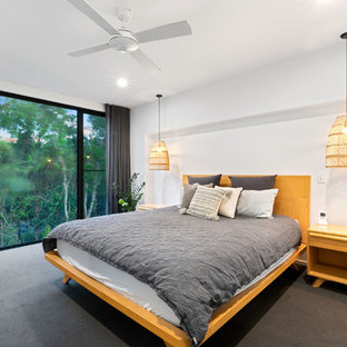 Design ideas for a large beach style master bedroom in Sunshine Coast with white walls, carpet and grey floor.
