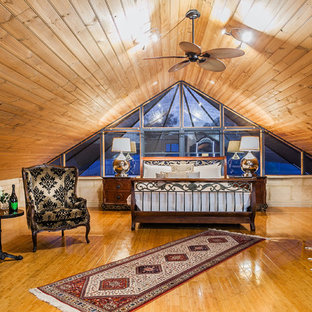 This is an example of a mediterranean master bedroom in Perth with brown walls, medium hardwood floors and beige floor.