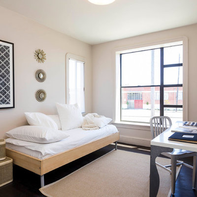 Example of a trendy dark wood floor bedroom design in San Francisco with beige walls
