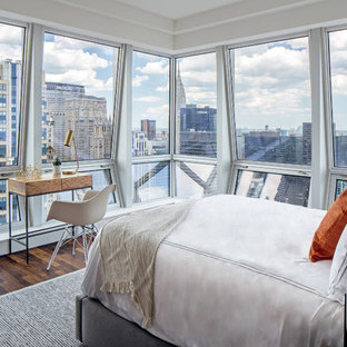 Example of a small trendy dark wood floor and brown floor bedroom design in New York with white walls