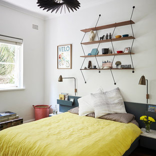 Design ideas for a mid-sized contemporary guest bedroom in Sydney with white walls, dark hardwood floors and brown floor.